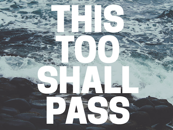 Quote: 'This too shall pass'. The text is bold and white and superimposed over an edited photo of some waves crashing against a rocky shore.